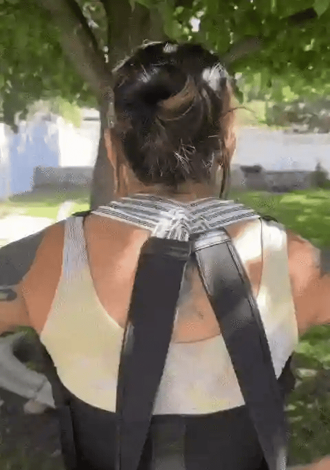 Woman wearing Aligno posture trainer to improve posture and relieve shoulder tension